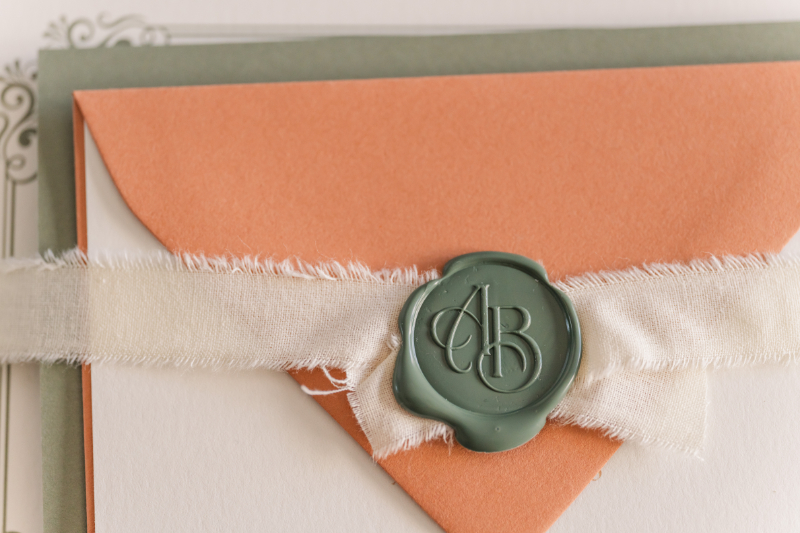 coral and green invites with personalized wax seal